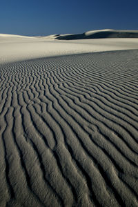 Sand dune in desert against sky