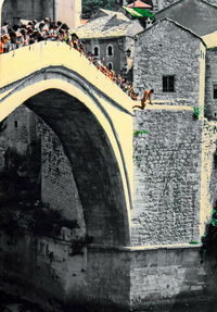 Arch bridge over buildings in city