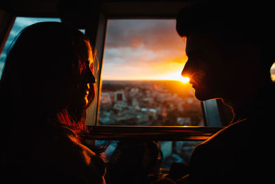 Rear view of woman looking through train window