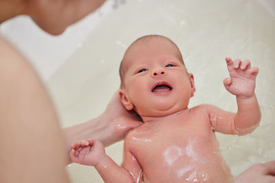 Cute baby taking bath in bathtub