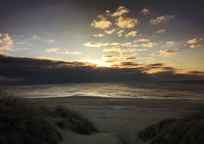 Scenic view of beach against sky during sunset