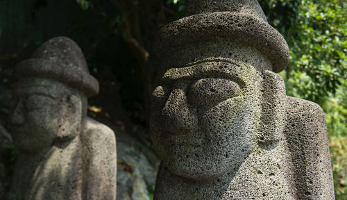 Close-up of buddha statue in cemetery