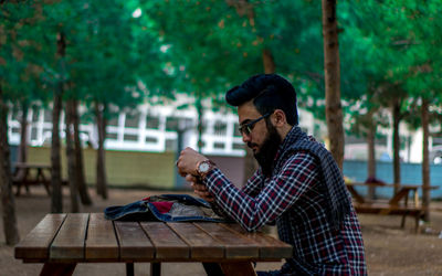 Side view of sitting on picnic table