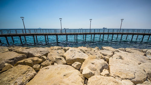 Rocks on beach against clear sky