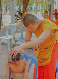 Boy playing in traditional clothing standing outdoors