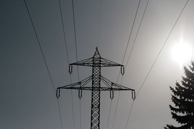 Low angle view of electricity pylon against sky