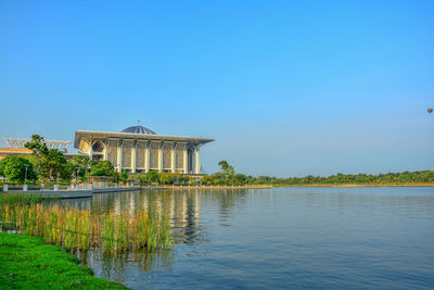 Built structure in water against clear sky