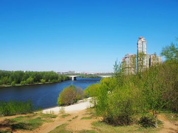 Scenic view of river against clear blue sky