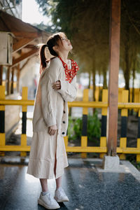 Rear view of woman standing against waterfall