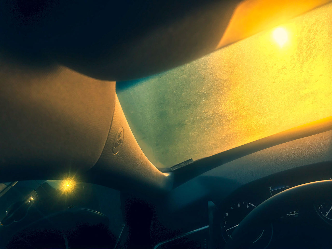 TILT IMAGE OF CAR AGAINST SKY AT SUNSET