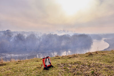 Firefighting backpack on the background of grassroots wildland fire. 