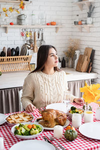 Portrait of woman having food at home