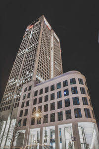 Low angle view of illuminated buildings against clear sky at night