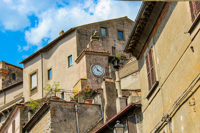 Low angle view of buildings against sky in town