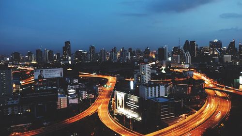 Illuminated buildings in city against sky at night