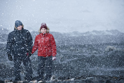 People on snow covered landscape during winter