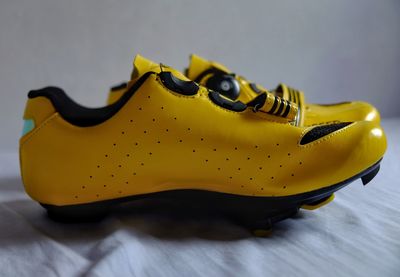 Close-up of yellow shoes on table