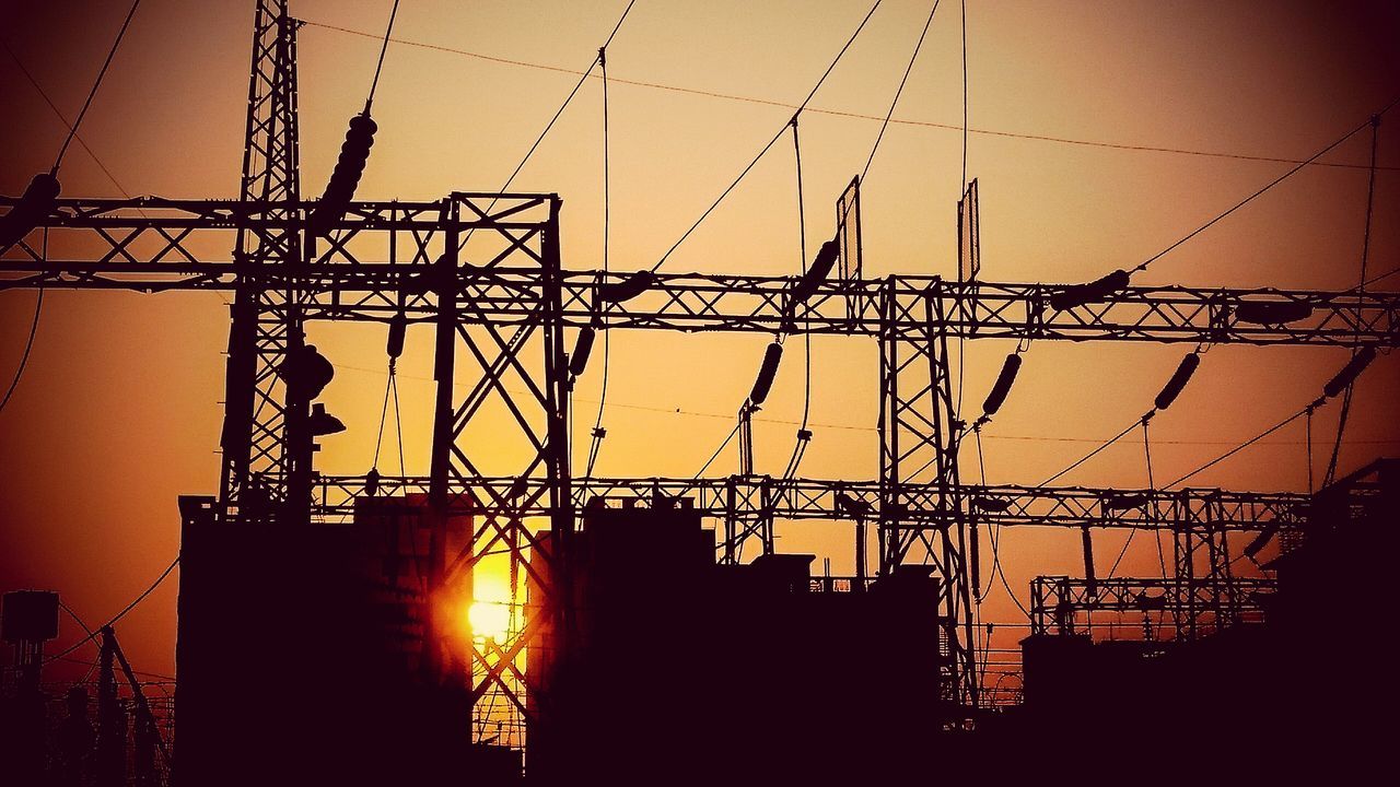 sunset, silhouette, electricity pylon, power line, orange color, electricity, connection, power supply, low angle view, fuel and power generation, sun, technology, built structure, clear sky, construction site, sky, architecture, crane - construction machinery, cable, sunlight