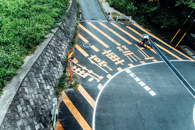 High angle view of man riding bicycle on road