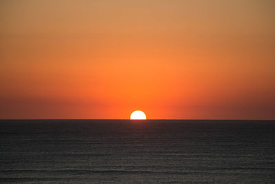 Scenic view of sea against romantic sky at sunset