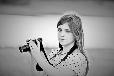 Portrait of girl holding camera