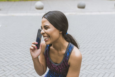 Beautiful hispanic woman using on the street