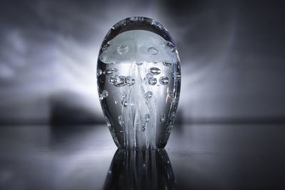 Close-up of water drop on glass table