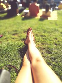 Low section of woman relaxing on grass