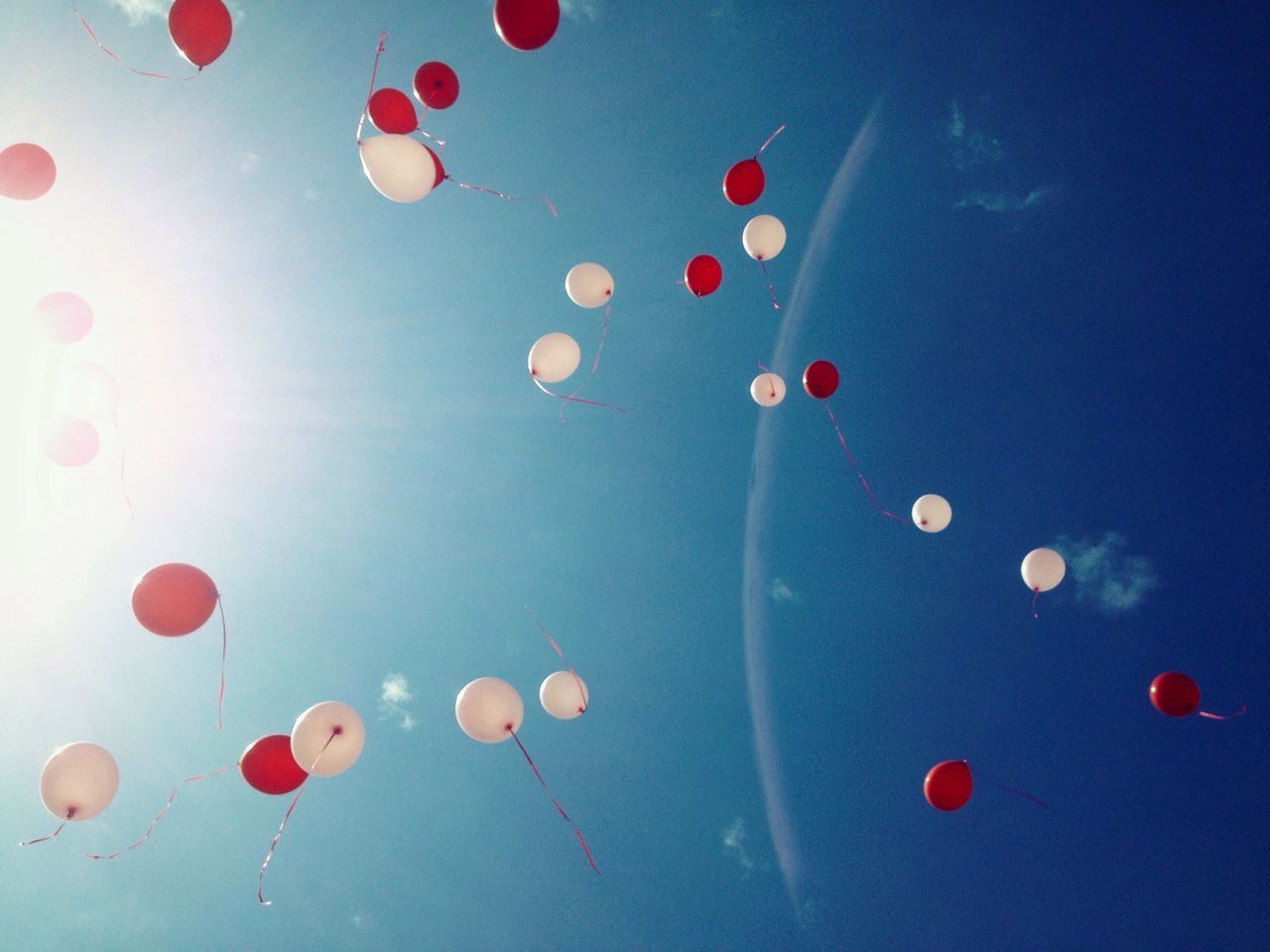 low angle view, red, multi colored, blue, sky, balloon, celebration, mid-air, no people, decoration, backgrounds, large group of objects, sphere, abundance, outdoors, flying, hanging, lighting equipment, beauty in nature, nature