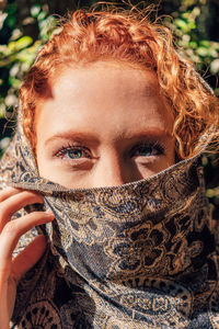 Close-up portrait of woman covering face