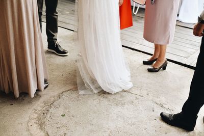 Low section of people at wedding party standing on floor