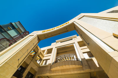 Low angle view of buildings against clear blue sky