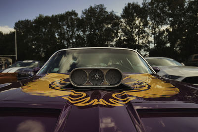 Close-up of yellow car on road