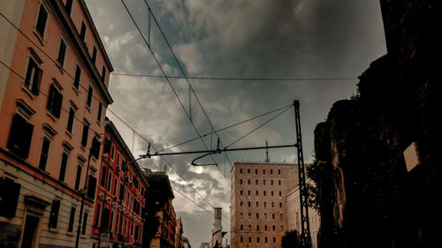 Low angle view of buildings against cloudy sky