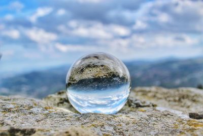 Close-up of crystal ball on rock