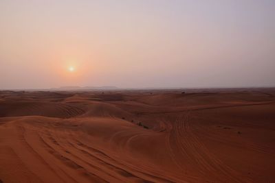 Scenic view of desert against sky during sunset