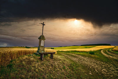 Scenic view of agricultural field against sky during sunset