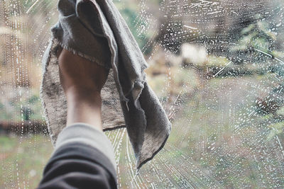 Low section of man standing by window