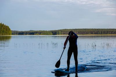 Rear view of man standing in water