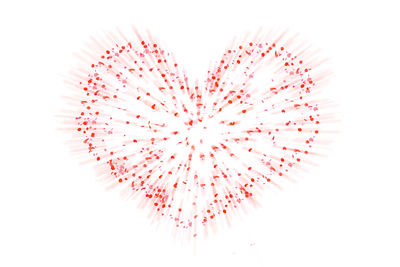 Directly above shot of pink decoration on white background