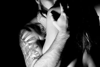 Close-up of young man against black background