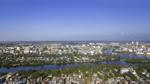 Panoramic view of sea and buildings against clear blue sky