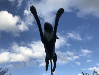 Low angle view of silhouette man standing against sky