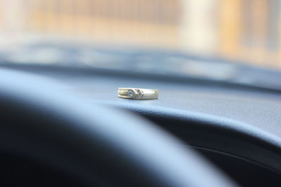 Close-up of wedding rings on car