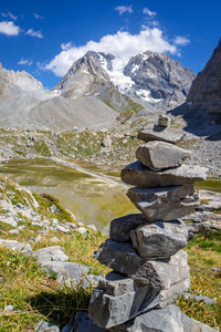 Stack of rocks on mountain against sky