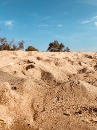 Sand dunes in desert against sky