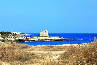 Scenic view of sea against blue sky