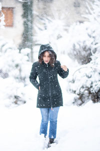 Full length of woman standing in snow