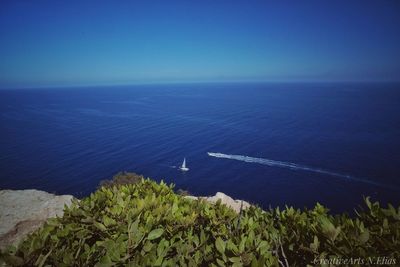 High angle view of sea against blue sky