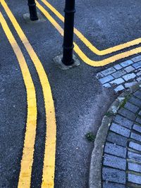 High angle view of yellow crossing sign on road